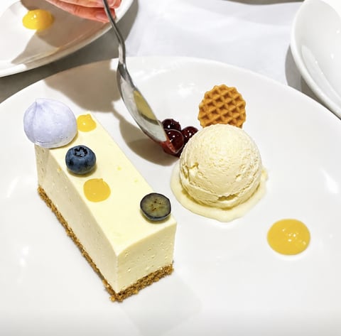 Cheesecake dessert with berries, ice cream and citrus curd